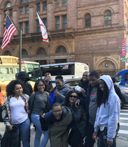 students standing in front of a building