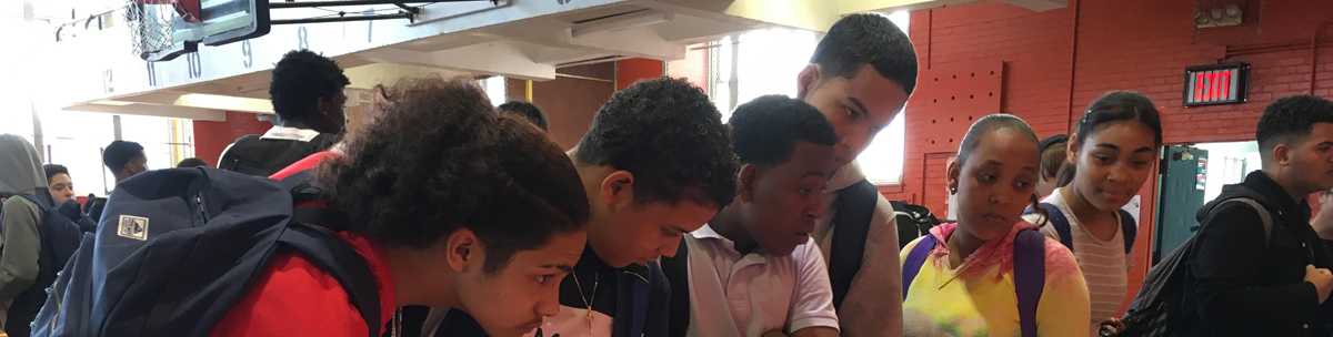 students listening at a college fair booth