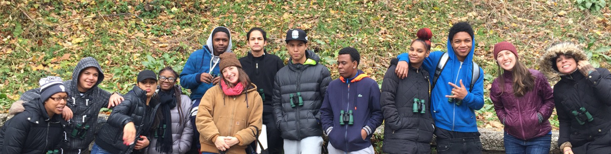 smiling students standing together on a field trip