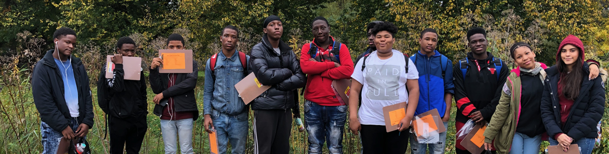 smiling students standing together on a field trip