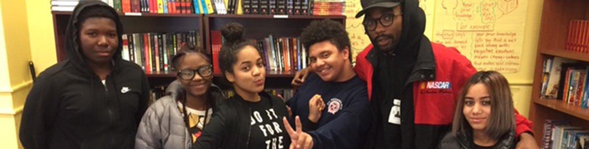 smiling students standing together in the library